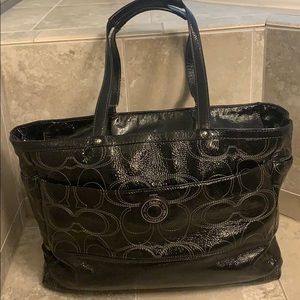 Black patent leather coach diaper bag.